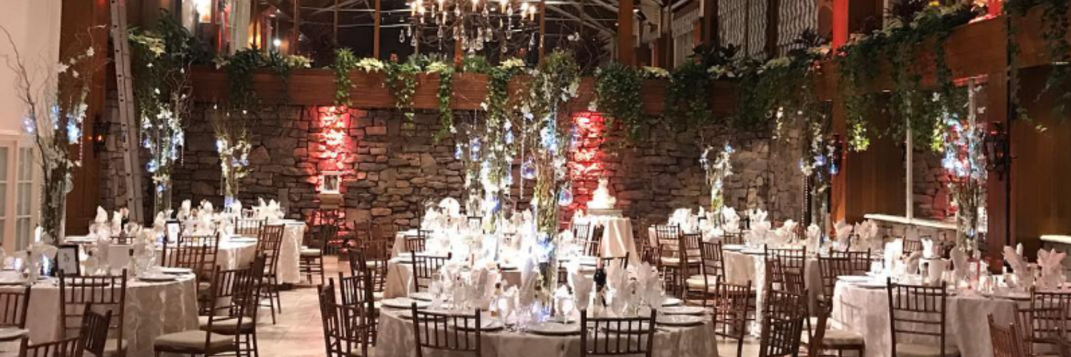 upscale wedding reception with ornate flower arrangements